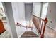 Carpeted stairway with wood banister leading to a bedroom and an entry way at 29049 Snapper Pt, Tega Cay, SC 29708