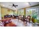 Bright sunroom featuring tile flooring and lovely outdoor views from many windows at 29049 Snapper Pt, Tega Cay, SC 29708