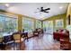 Inviting sunroom with a fan and plenty of natural light through large windows at 29049 Snapper Pt, Tega Cay, SC 29708