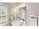 Bright bathroom with a large mirror, white sink, and window providing natural light at 3007 Colonel Springs Way, Fort Mill, SC 29708