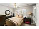 Cozy bedroom with a ceiling fan, natural light, and dark wooden furniture at 3007 Colonel Springs Way, Fort Mill, SC 29708