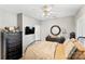 Comfortable bedroom featuring a dresser, ceiling fan, and round mirror at 3007 Colonel Springs Way, Fort Mill, SC 29708