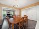 Dining room with wood table, chandelier, and views to the living room at 3014 Robin Terry Ct, Charlotte, NC 28208
