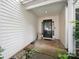 Covered porch leads to the home's front door featuring glass and side panel at 3014 Robin Terry Ct, Charlotte, NC 28208