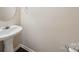 Modest half bathroom with pedestal sink, mirror, and neutral walls at 3014 Robin Terry Ct, Charlotte, NC 28208