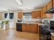 Functional kitchen featuring wood cabinets, black appliances, and laminate countertops at 3014 Robin Terry Ct, Charlotte, NC 28208