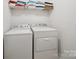 Laundry room with a stacked washer and dryer and overhead storage shelving at 3014 Robin Terry Ct, Charlotte, NC 28208