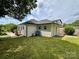 Backyard featuring manicured green grass, a deck, and a fence at 306 Sacco St, Belmont, NC 28012