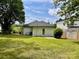 Backyard of house with grass, blue trash cans, and a privacy fence at 306 Sacco St, Belmont, NC 28012