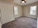 Bedroom with gray carpet, ceiling fan, and double windows at 306 Sacco St, Belmont, NC 28012