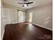 Bedroom featuring wood flooring, a fan, closet, and access to the outside at 306 Sacco St, Belmont, NC 28012