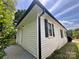 Close up view of house exterior, featuring white siding and black trim at 306 Sacco St, Belmont, NC 28012