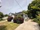 Cozy single-story home with a manicured lawn, charming bushes, and an inviting exterior appeal at 306 Sacco St, Belmont, NC 28012