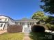 Inviting single-story home with a classic facade, landscaped bushes, and a well-manicured lawn at 306 Sacco St, Belmont, NC 28012