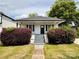 Charming single-story home featuring a cozy front porch and well-maintained landscaping at 306 Sacco St, Belmont, NC 28012