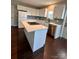 Modern kitchen with white cabinets, an island cooktop, and stainless steel appliances at 306 Sacco St, Belmont, NC 28012