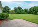 Expansive backyard featuring lush green grass and mature trees at 3537 Heather Ln, Gastonia, NC 28056