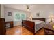 Bedroom with hardwood floors, dresser, and a window providing natural light at 3537 Heather Ln, Gastonia, NC 28056