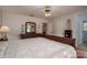 Bedroom with a dresser, lamps, a neutral comforter, and an ensuite bathroom at 3537 Heather Ln, Gastonia, NC 28056