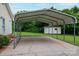 The photo shows the carport attached to a home, a concrete pad, and view of the storage building in the backyard at 3537 Heather Ln, Gastonia, NC 28056