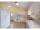 Well-lit kitchen featuring white appliances and cabinets, offering a clean and functional space at 3537 Heather Ln, Gastonia, NC 28056