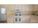 Close-up of a kitchen with white appliances and countertops, ideal for cooking and entertaining at 3537 Heather Ln, Gastonia, NC 28056