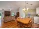 Open-concept living area with a cozy brick fireplace, adjacent dining, and kitchen area at 3537 Heather Ln, Gastonia, NC 28056