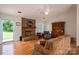 Cozy living room featuring a brick fireplace and hardwood floors with a comfortable seating area at 3537 Heather Ln, Gastonia, NC 28056