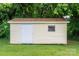 The photo presents the outdoor storage shed on a grassy lawn, with vertical siding and a single window at 3537 Heather Ln, Gastonia, NC 28056