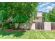 Grassy backyard featuring a privacy fence, mature shade tree, and neutral siding of home at 3617 Willow Point Dr, Charlotte, NC 28277