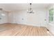 Spacious living room featuring luxury vinyl floors, modern light fixture, and a view of the front entrance at 406 N Bostian St, China Grove, NC 28023