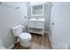 Well-lit bathroom showcasing a white vanity, a framed mirror, and neutral wall colors for a clean aesthetic at 4209 Donnybrook Pl, Charlotte, NC 28205