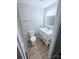 This bathroom features a modern vanity with light countertops, complemented by wood-look flooring at 4209 Donnybrook Pl, Charlotte, NC 28205
