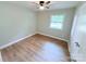 Bright bedroom featuring a ceiling fan and a window overlooking the backyard at 4209 Donnybrook Pl, Charlotte, NC 28205