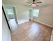 Bright bedroom with a ceiling fan, light-colored walls, and wood-look flooring at 4209 Donnybrook Pl, Charlotte, NC 28205