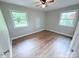 Sun-filled bedroom with two large windows and hardwood floors, providing a comfortable space at 4209 Donnybrook Pl, Charlotte, NC 28205