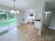 Bright kitchen featuring new stainless steel appliances, white cabinetry, and a sliding glass door to the backyard at 4209 Donnybrook Pl, Charlotte, NC 28205