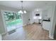 Bright kitchen featuring new stainless steel appliances, white cabinetry, and a sliding glass door to the backyard at 4209 Donnybrook Pl, Charlotte, NC 28205