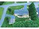 Birds eye view of a house with mature trees, a long driveway, and an inviting backyard patio at 4646 River Run Cir, Hickory, NC 28602