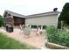 Outdoor living on a brick patio featuring a dining set, unique decorations, and a lovely garden space at 4646 River Run Cir, Hickory, NC 28602