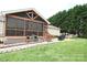 Expansive back yard with a screened porch, brick patio, and lush green lawn at 4646 River Run Cir, Hickory, NC 28602