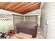 Enclosed outdoor area featuring a hot tub, wooden beams, and partial lattice fencing at 4646 River Run Cir, Hickory, NC 28602