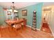 Traditional dining room features wood floors, textured green walls, and stylish light fixture at 4646 River Run Cir, Hickory, NC 28602