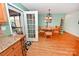 Inviting dining room with wood floors, stylish lighting, and convenient access to the screened porch at 4646 River Run Cir, Hickory, NC 28602