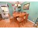 Charming dining room featuring hardwood floors, stylish lighting, and convenient access to outdoor living spaces at 4646 River Run Cir, Hickory, NC 28602