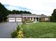 Charming brick ranch with a well-manicured lawn, beautiful flowerbeds, and a spacious two-car garage at 4646 River Run Cir, Hickory, NC 28602