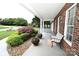 Cozy front porch with a bench, potted plants, and lovely landscaping, a welcoming entrance at 4646 River Run Cir, Hickory, NC 28602