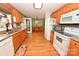 Efficient kitchen layout with wood cabinetry, granite countertops, and white appliances at 4646 River Run Cir, Hickory, NC 28602
