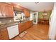 Charming kitchen featuring wood cabinets, granite countertops, stainless steel sink, and hardwood floors at 4646 River Run Cir, Hickory, NC 28602
