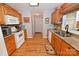 Well-designed kitchen with hardwood floors, granite countertops, wood cabinets, and stainless steel sink at 4646 River Run Cir, Hickory, NC 28602
